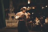 amateur tango couple dancing in a dark milonga