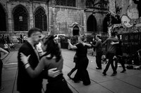 dancers in a street milonga next to a church