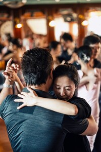 couple dancing with a passionate embrace in a milonga